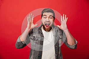 Photo of happy ecstatic guy 30s wearing beard in jeans jacket sc