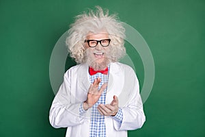 Photo of happy excited crazy mad scientist clapping evil laugh wear long white coat and glasses isolated on green color
