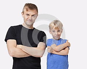 Portrait of happy father and son in casuals with arms crossed over white background photo