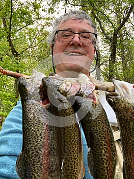 Happy Fisherman With Rainbow Trout photo