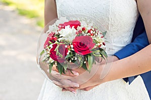 Photo of happy just married wedding couple holding a bouquet