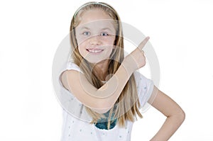 Photo of happy little girl standing isolated over white wall background. Adorable little girl showing back copyspace pointing.