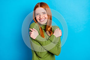 Photo of happy lovely sweet young woman hug herself good mood smile isolated on blue color background
