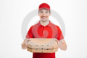 Photo of happy man from delivery service in red t-shirt and cap
