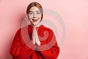 Photo of happy nice woman smiling and holding palms together