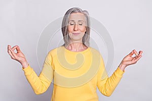 Photo of happy positive good mood dreamy woman doing yoga meditating relaxing isolated on grey color background