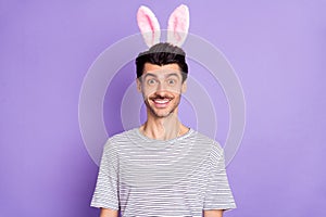 Photo of happy smiling cheerful good mood funky man wear bunny rabbit ear easter isolated on purple color background