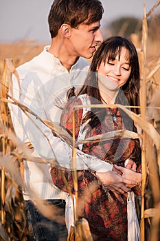 Happy young couple in autumn corn field