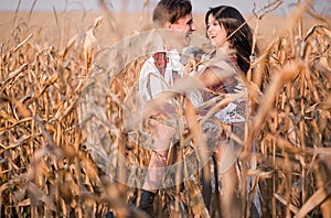 Happy young couple in autumn corn field