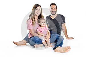 Photo of the happy young family with little child sitting on the floor