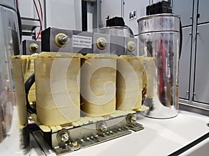 Photo of harmonic reactor with capacitor bank in electrical cabinet.