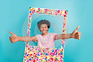 Photo of having fun youngster handsome man wear pink t-shirt funny chevelure hairo thumbs up paper borders frame