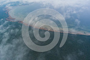 Photo from a high altitude, clouds over the forest and seashore in Kaberneeme