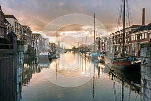 Photo of the historic Delfshaven with beautiful colored clouds in Rotterdam