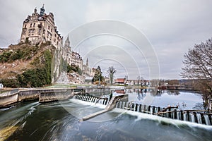 Photo of Hohenzollern Castle in Sigmaringen with barrage waterfall and reservoir in foreground, Germany