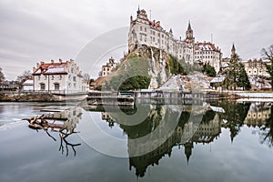 Photo of Hohenzollern Castle in Sigmaringen with barrage waterfall and reservoir in foreground, Germany