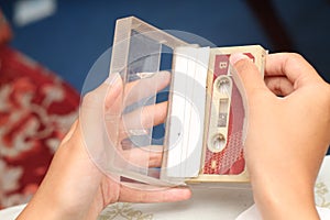 Photo of holding a cassette tape, version 9