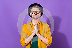 Photo of hopeful young charming man hold hands ask beg please wear glasses isolated on violet color background