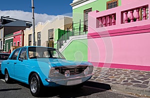 Photo of houses in the Malay Quarter, Bo-Kaap, Cape Town, South Africa with vintage Ford Cortina car outside on street.
