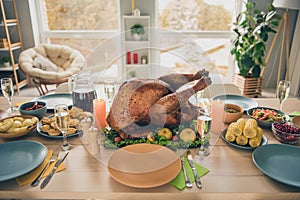 Photo of huge tasty roasted turkey standing holiday table waiting big family gathering indoors room home