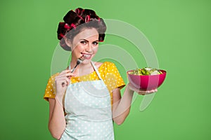 Photo of hungry retro girl want eat organic fresh dinner lunch bowl salad touch fork teeth wear yellow dotted dress hair