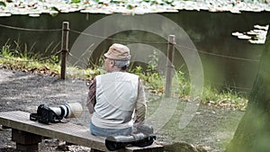 Photo hunter with his telephoto lenses