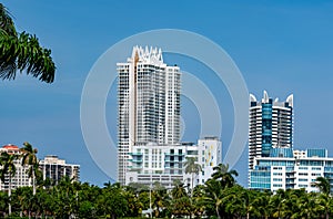 Photo of iconic highrise condominium buildings in Miami Beach shot with telephoto lens on blue sky