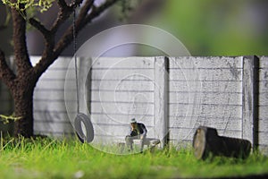 Photo Illustration, Sitting Hopeless Sad Old Man Mini Figure Toy under the tree