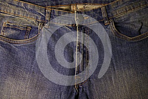 Photo image of bright blue beautiful new jeans closeup