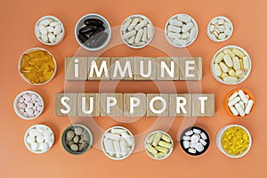 Photo on immune support theme. wooden cubes with the inscription `immune support` and biologically active supplements photo