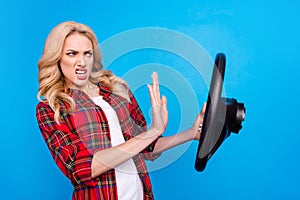 Photo of impressed angry young woman dressed checkered shirt driving vehicle beeping isolated blue color background