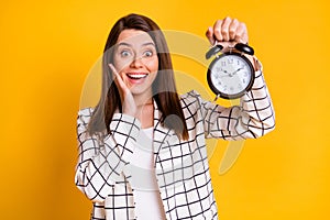 Photo of impressed business woman wear white checkered blazer hold bell arm face cheekbone isolated yellow color