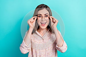 Photo of impressed cute girl dressed pink shirt open mouth hands arms eyewear open mouth isolated teal color background