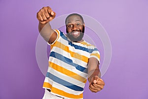 Photo of impressed funky man wear striped t-shirt driving automobile isolated violet color background