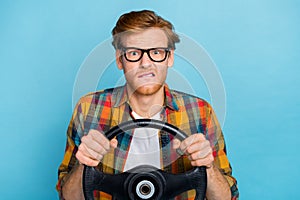 Photo of impressed person speechless looking at camera holding steering wheel unexpected accident isolated on blue color