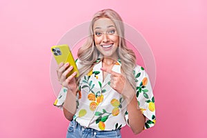 Photo of impressed pretty girl dressed print blouse indicating at smartphone facebook instagram whatsapp  on