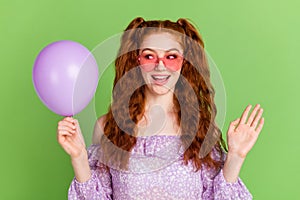 Photo of impressed red hairstyle young lady hold balloon wear violet blouse spectacles isolated on green color