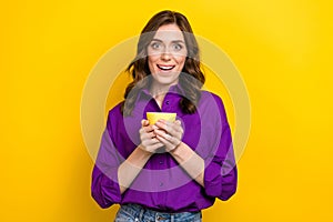 Photo of impressed woman with curly hair dressed purple shirt hands hold cup of late astonished staring isolated on