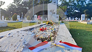 Photo of the Indonesian flag on the graves of heroes as the background on Indonesian Independence Day Landscape