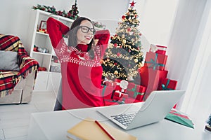 Photo of inspired relax businesswoman finish job enjoy rest wear santa hat sweater in decorated x-mas home indoors