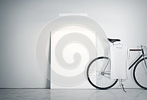 Photo Interior Modern Studio Loft with Concrete Wall and Classic bicycle.Empty White Canvas on Floor, Spotlight top