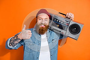Photo of irish funny redhair guy thumb up dj music lover hold boom box retro party bearded tattooed person isolated on