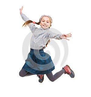 Photo of joyful little girl jumping