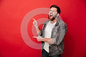 Photo of joyous man in casual clothing bursting in laughter and photo