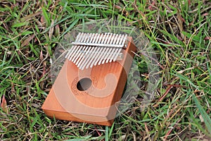 Photo Kalimba, acoustic music instrument from africa and its soft cover at Grass