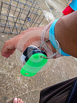 photo of the key chain on a man's left wrist