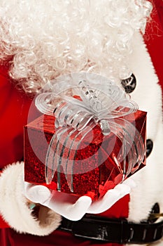 Photo of kind Santa Claus giving xmas present and