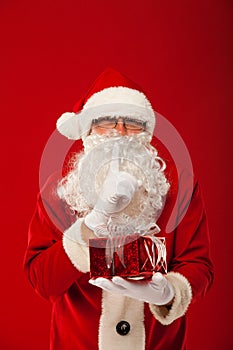 Photo of kind Santa Claus giving xmas present and