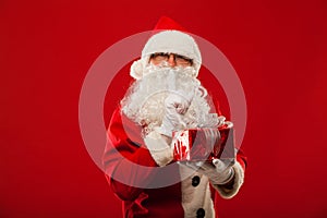 Photo of kind Santa Claus giving xmas present and