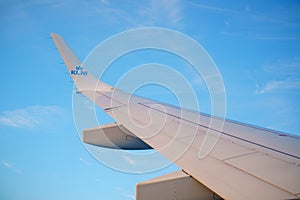 Photo of a KLM airplane wing on a blue sky